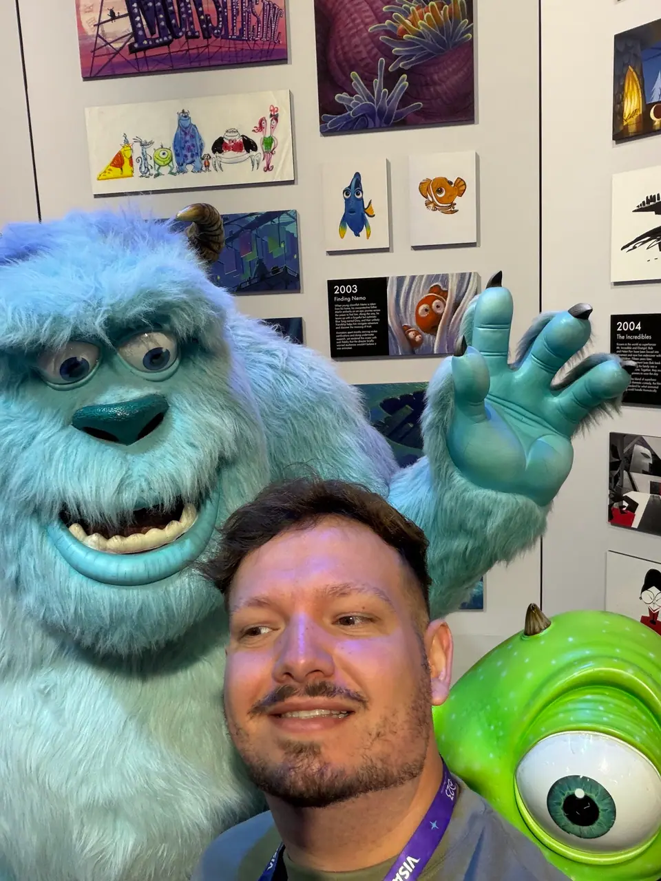 Selfie divertida do Thomaz entre Sulley e Mike (Monstros S.A.) na exposição Pixar do D23